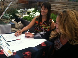 ECPAT USA Michelle Guelbart signing Code with Malia Everette Altruvistas