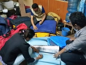 HHT staff including Sushma Tamang pack trekking gear for people in need.