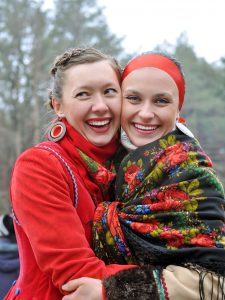 outdoor portrait of two young ukrainian women in traditional ukrainian clothes