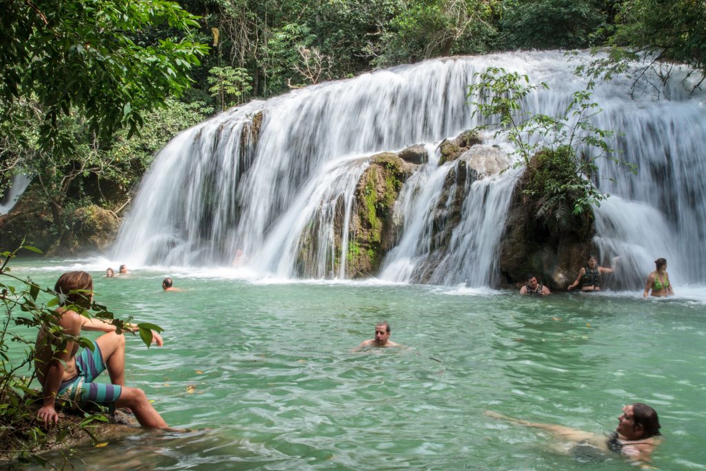AdventureWeek Brazil participants enjoying a beautiful landscape and refreshing swim at one of the waterfalls in Estancia Mimosa. © ATTA / Hassen Salum